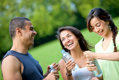 people holding bottles of water outdoors